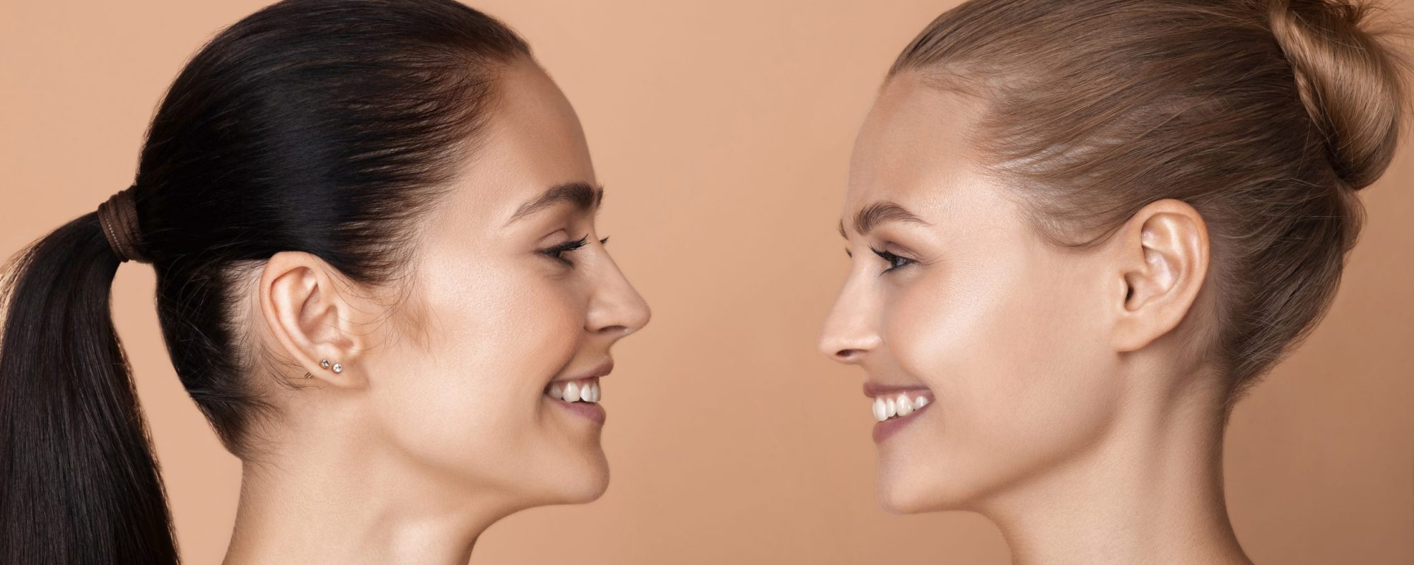 Portrait of beautiful young women isolated on brown studio background Portrait of beautiful young women isolated on brown studio background. Caucasian female models looking and smiling. Concept of women's health and beauty, self-care, body, skin care, treatment.